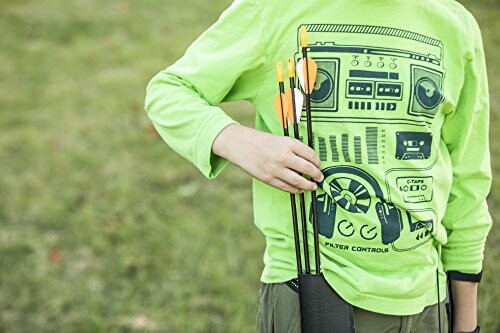 Child in green shirt holding arrows in a quiver.