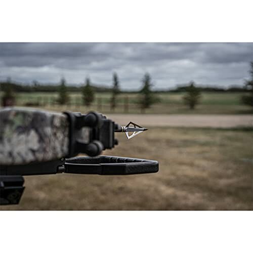 Close-up of a crossbow with an arrow outdoors.